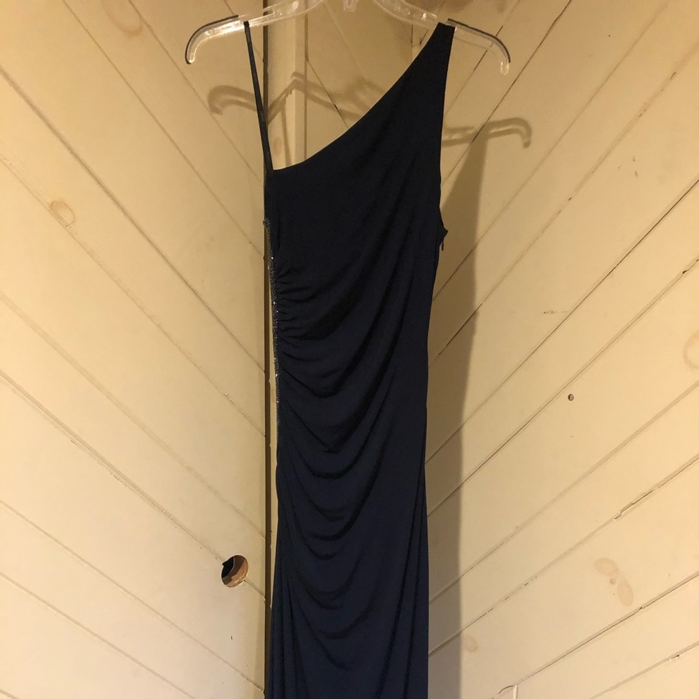 Long, one shoulder navy dress with side beading.